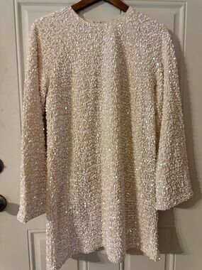White H&M sequin mini dress featuring a round neckline and long sleeves. Sz S